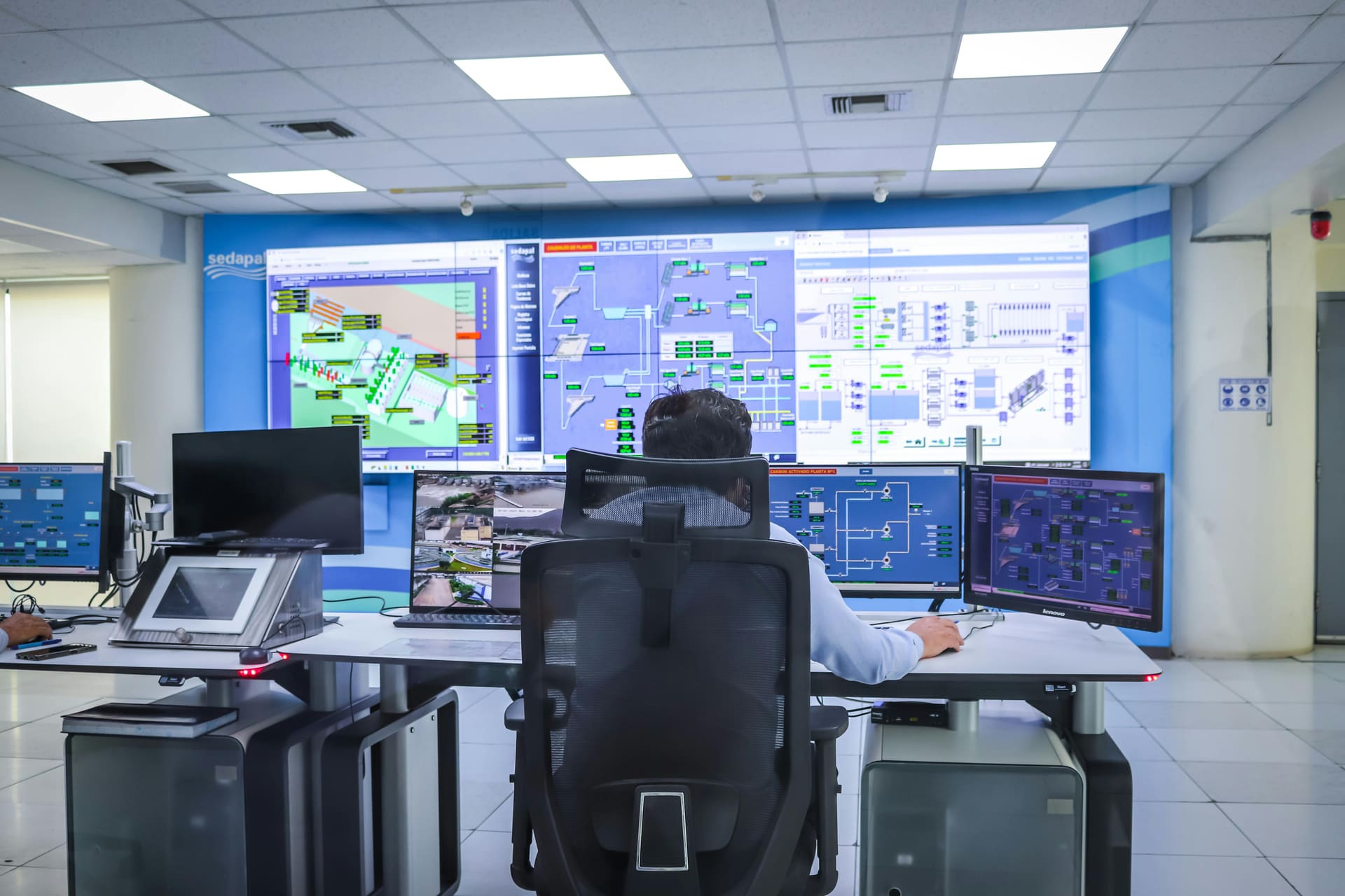 Industrial terminal gantry and control room at dusk, where an embedded engineer would work alongside the operator's team.